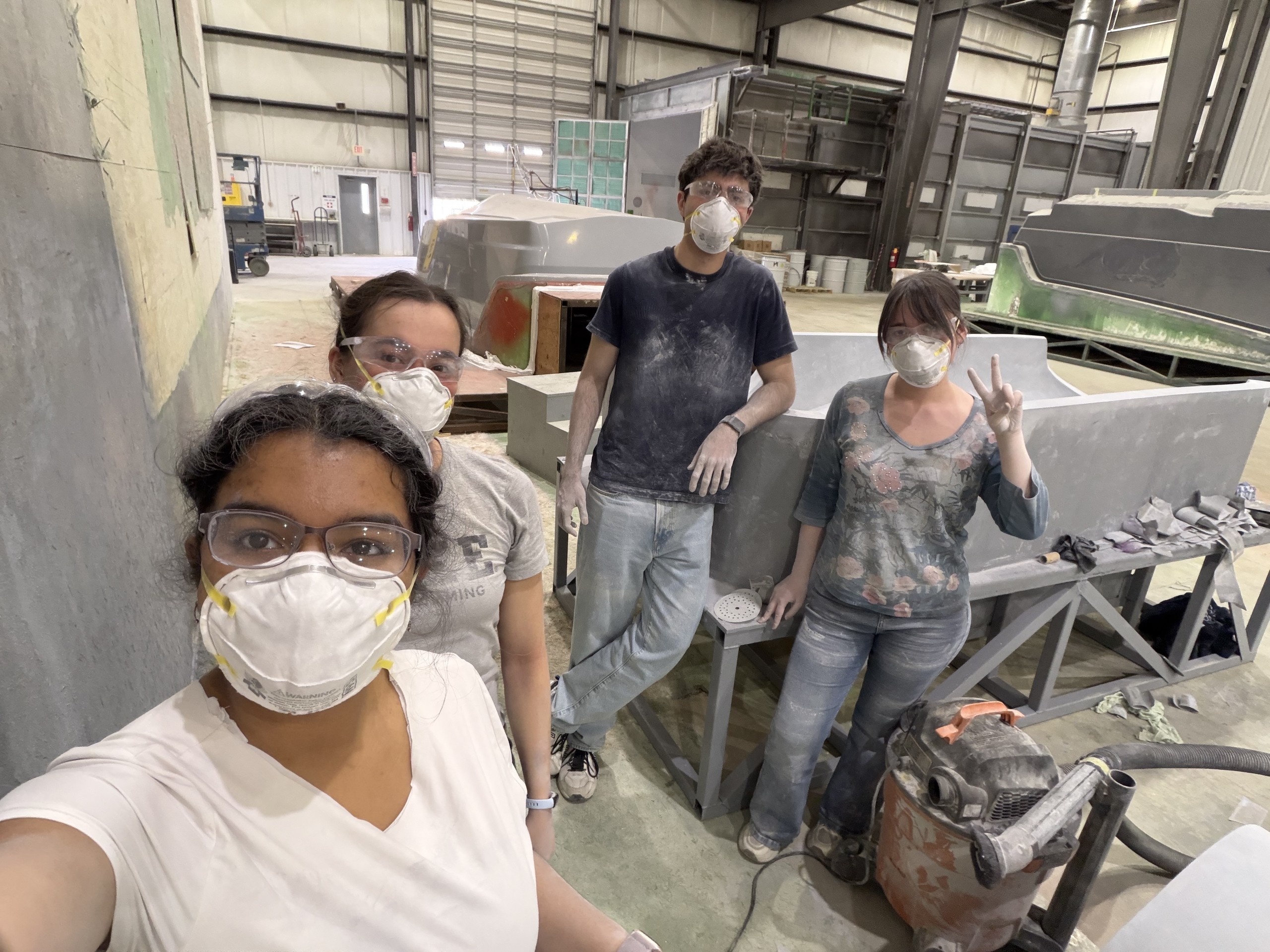 Sanding the full-scale body molds at the composites facility